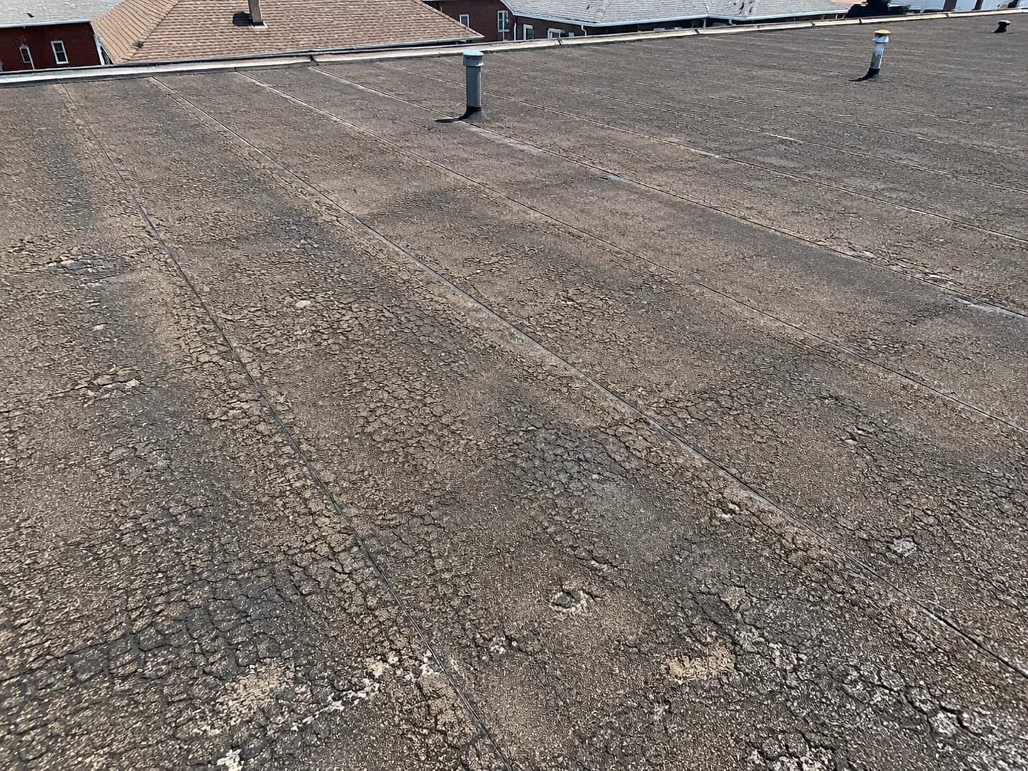 Weathered commercial roof before any restoration work